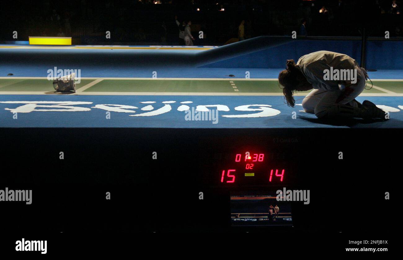 Tunisia's Azza Besbes cries on the floor following her quarterfinals