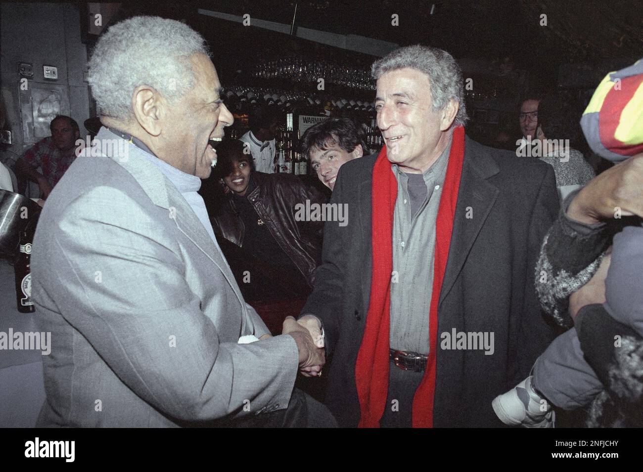 Trumpet playing legend, Dizzy Gillespie, left, greets renowned singer