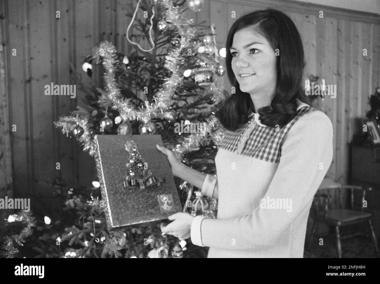 Barbara Jane Mackle trims the Christmas tree at her home in Miami, Dec