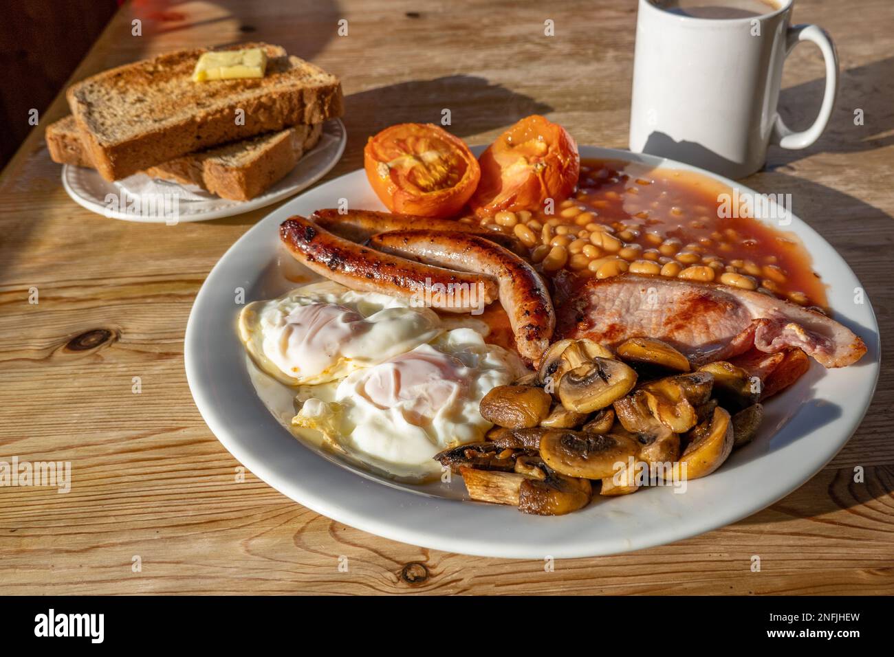 Traditional Full English Breakfast with Eggs, Bacon, Sausage, and Baked