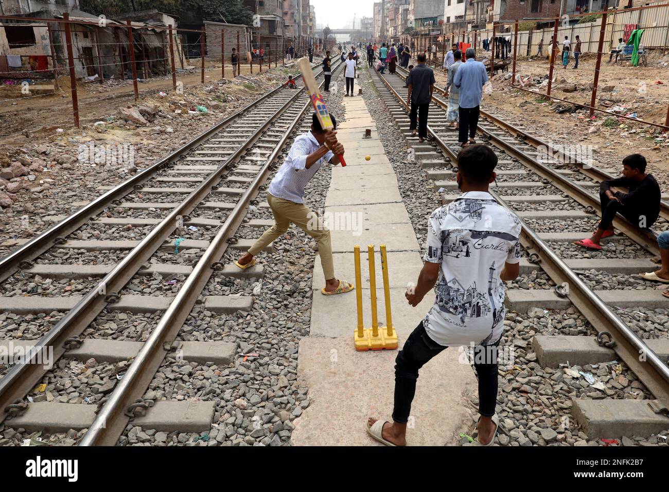 February 17, 2023, Dhaka, Dhaka, Bangladesh: Due to lack of adequate playground in Dhaka, boys are playing cricket between two railway lines. (Credit Image: © Syed Mahabubul Kader/ZUMA Press Wire) EDITORIAL USAGE ONLY! Not for Commercial USAGE! Stock Photo
