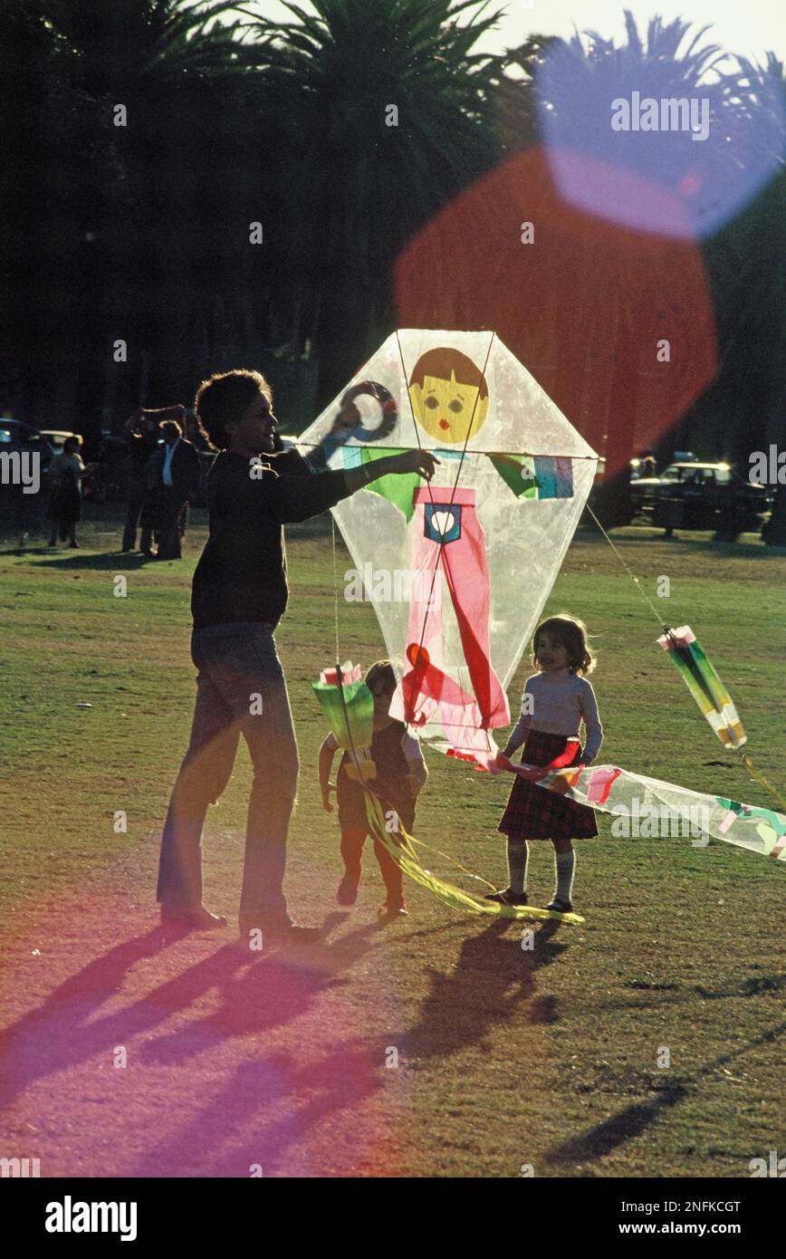 Australia. Sydney. Father and children flying a kite in the park. Stock Photo