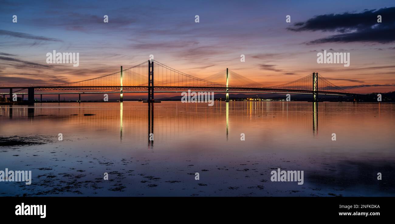 Panoramic view of Forth Road Bridge and Queensferry Crossing at sunset from South Queensferry, Scotland, UK Stock Photo