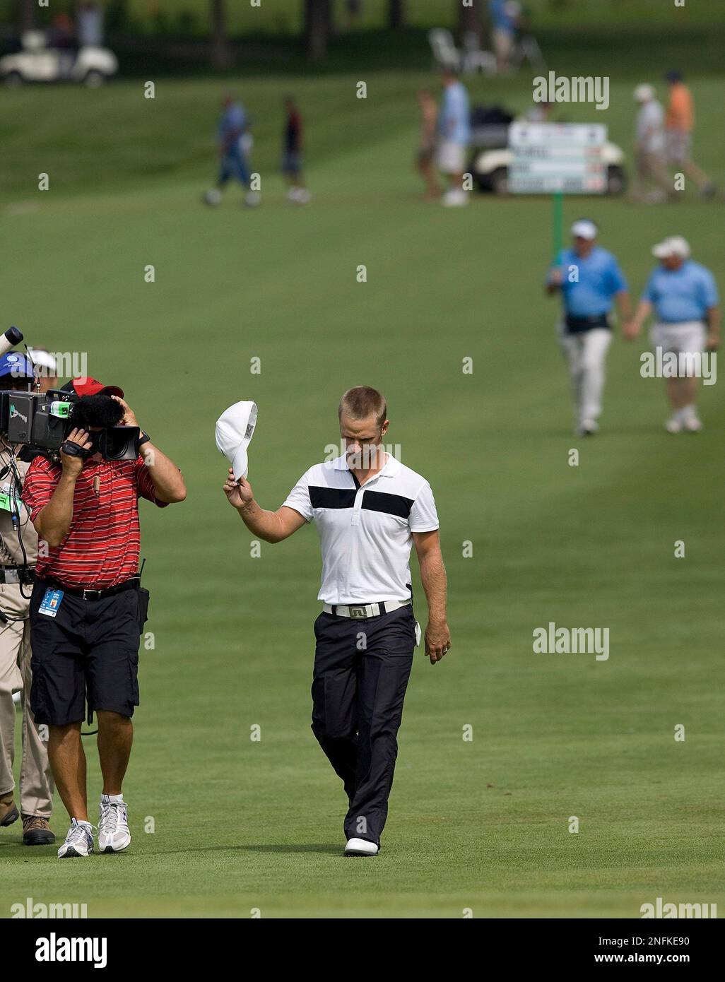 Richard S. Johnson of Sweden tips his hat as he walks up the18th hole  during the final round of the US Bank Championship golf tournament Sunday,  July 20, 2008, in Milwaukee. Johnson