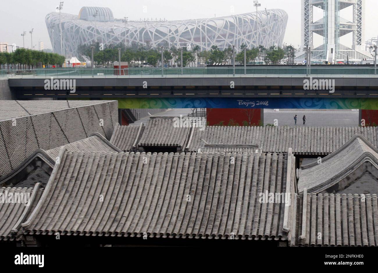 visitors-walk-near-a-replica-of-chinese-courtyard-houses-built-in-the