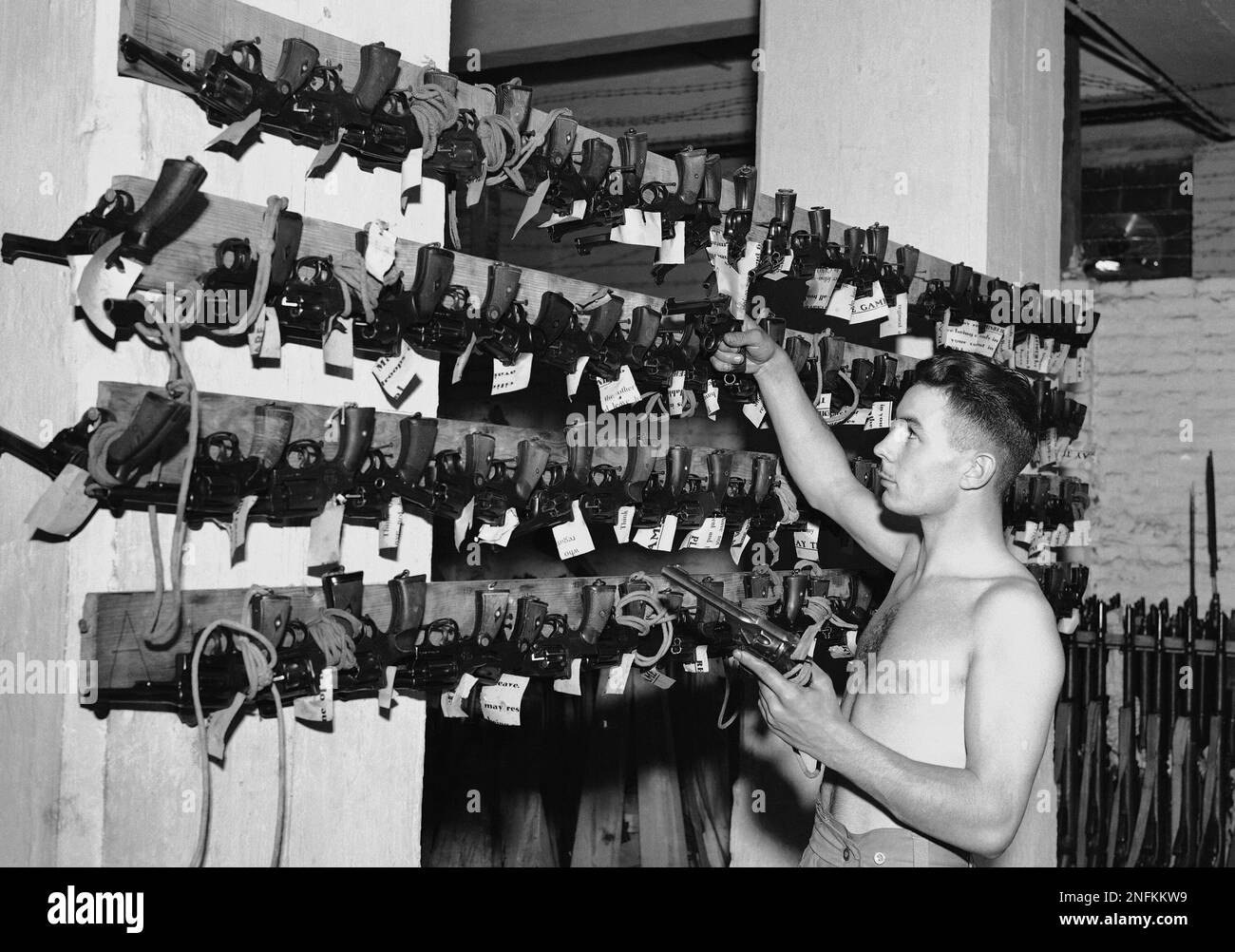 Side arms are placed on the racks after cleaning with tickets attached ...