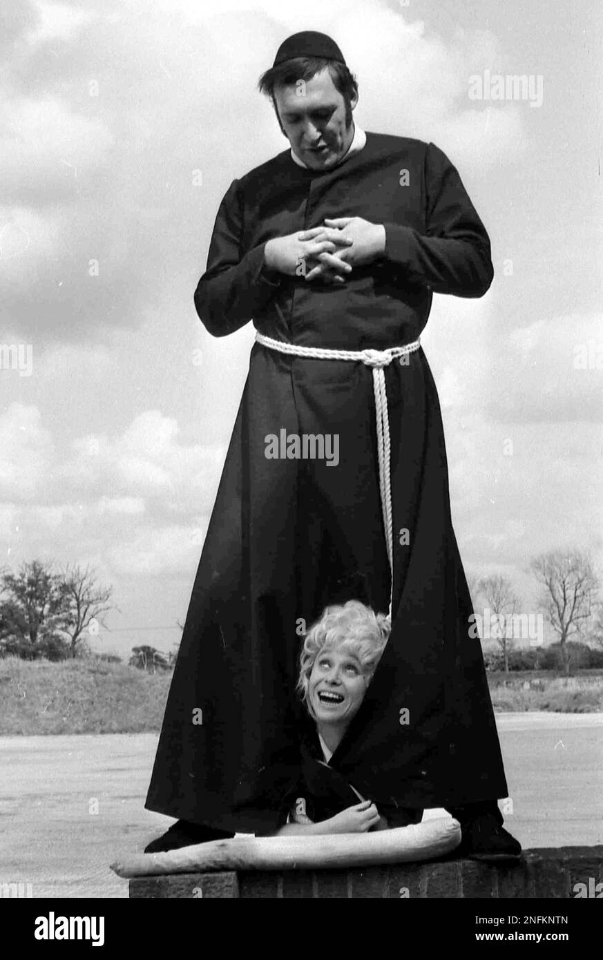 British comedy actor Bernard Bresslaw, dressed in a cassock for the