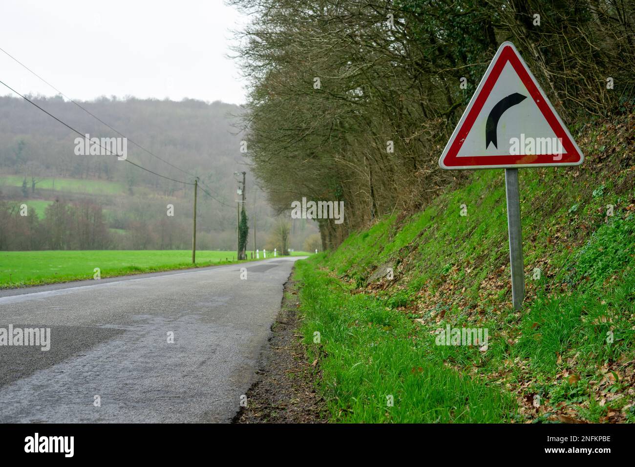 Dangerous turns, triangle warning traffic sign near rural road Stock Photo  - Alamy