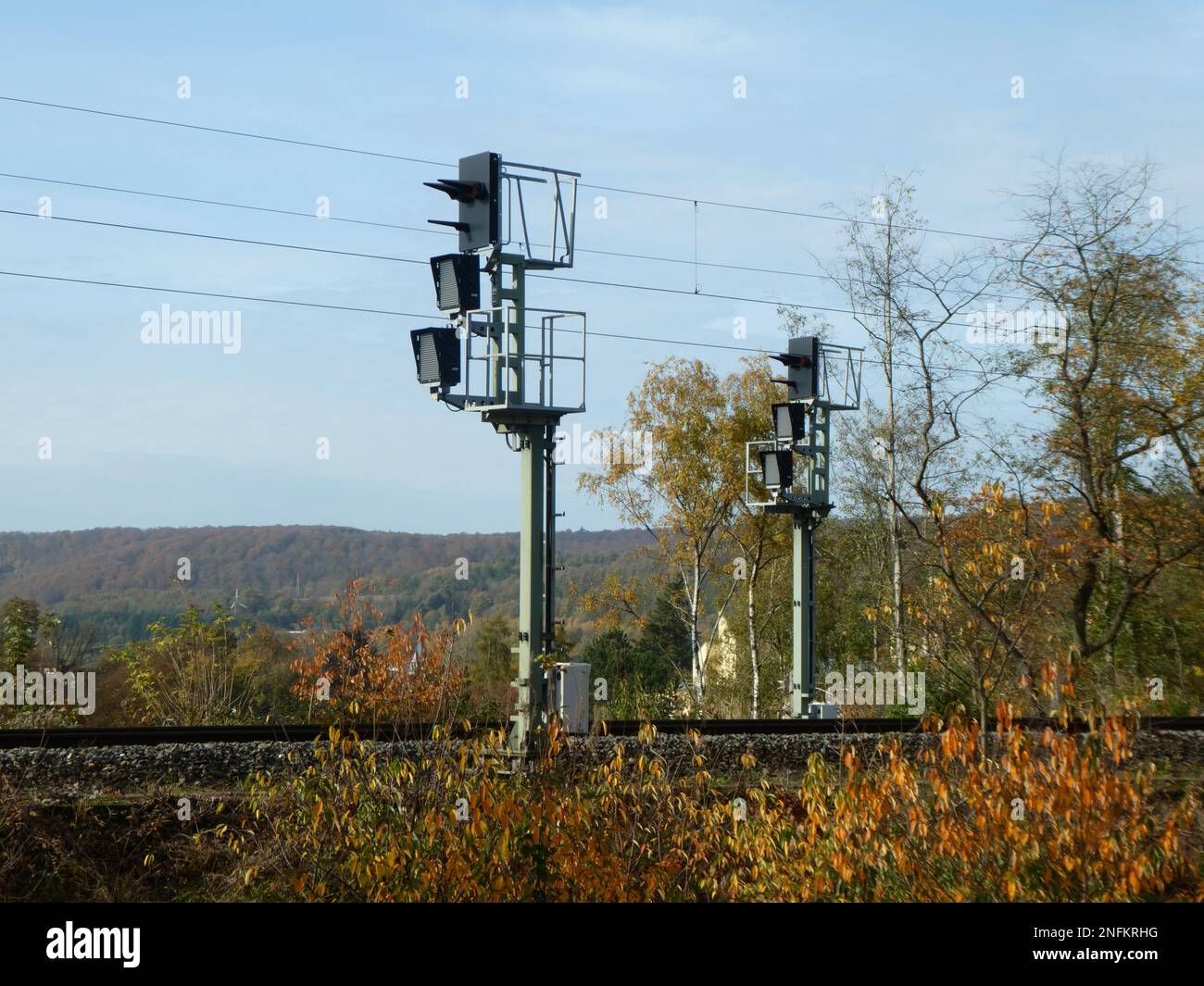 Railway signals with track in sunny autumn landscape Stock Photo