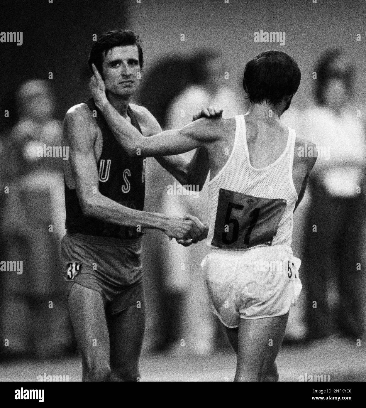 Marathon runner Frank Shorter, left, shakes hands with East Germany's Waldemar Cierpinski after ...