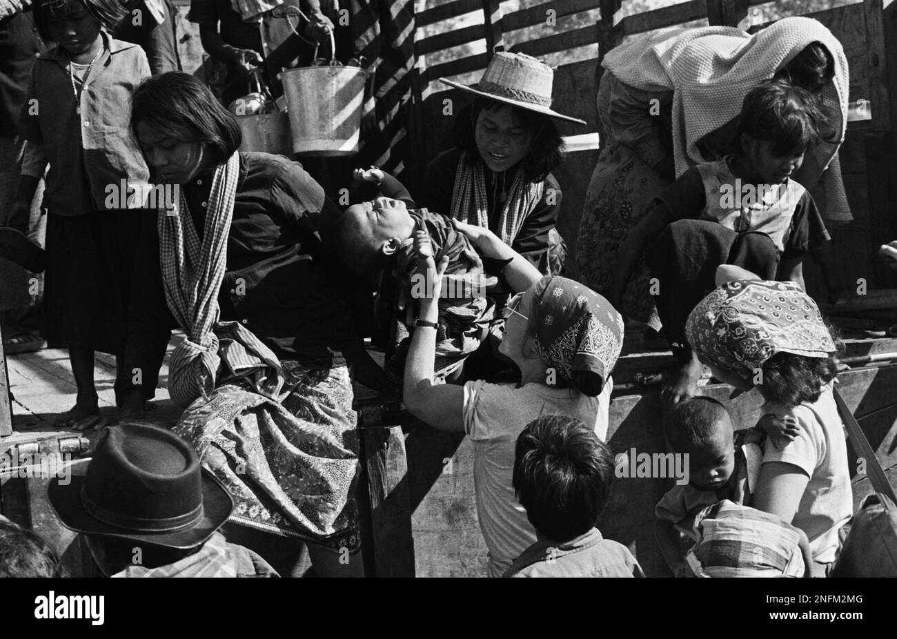 Andrea Kmetz, an American relief worker, receives a refugee boy from