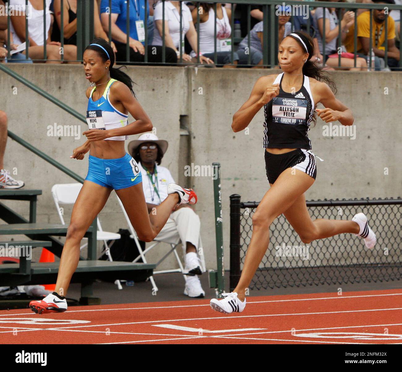 Allyson Felix, right, crosses the finish line with Muna Lee in the