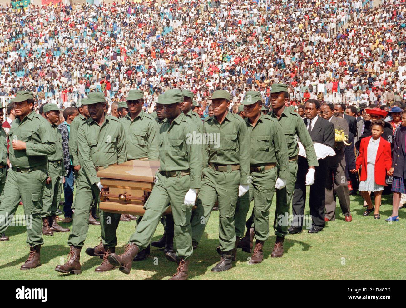 Pallbearers from the African National Congress' armed wing carry the ...