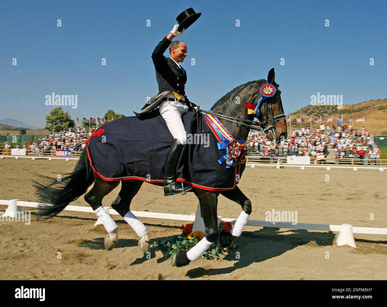Steffen Peters, of the United States, takes a victory lap on his horse