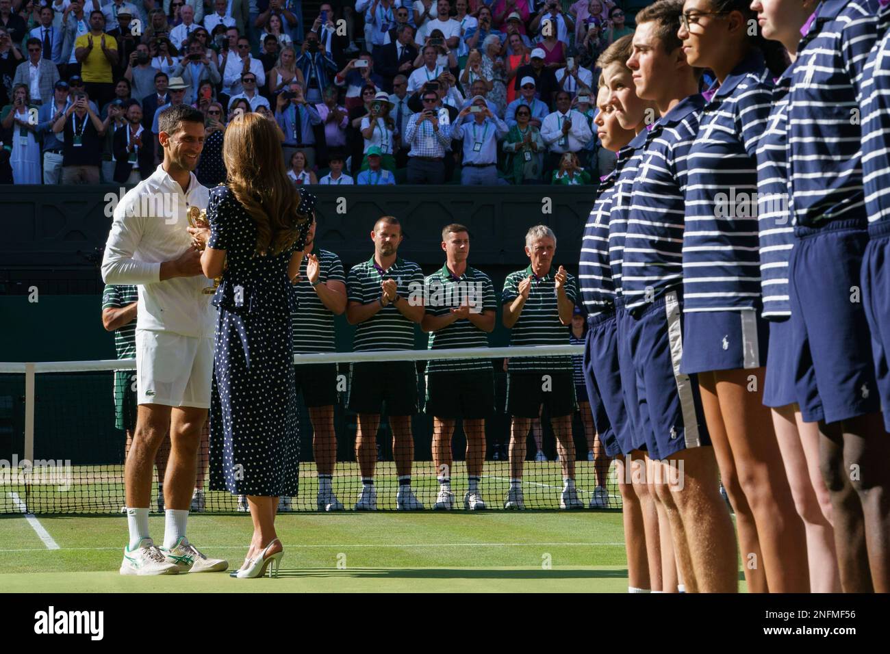 HRH Catherine, The Princess of Wales presents MenÕs Singles Champion Novak Djokovic with his winners trophy at the 2022 Wimbledon Championships. Held Stock Photo