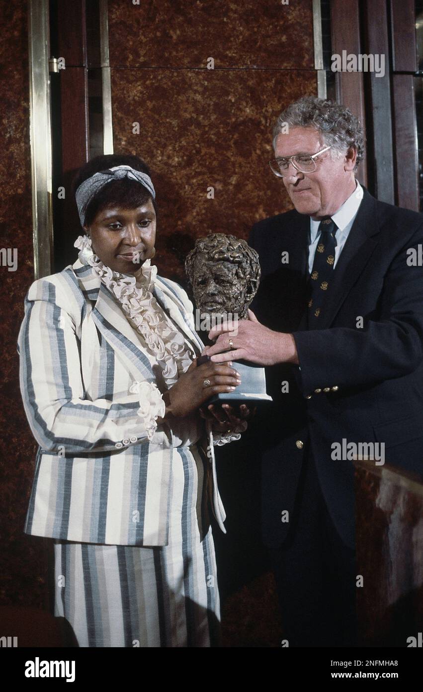 Winnie Mandela, wife of African Guerrilla leader Nelson Mandela, in Johannesburg, South Africa, when she receives the Robert Kennedy human rights award Jan. 24, 1986. Man at right is unidentified. (AP Photo/Greg English) Stock Photo