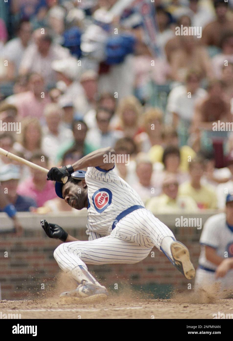 Chicago Cubs' Andre Dawson goes down after being hit in the face