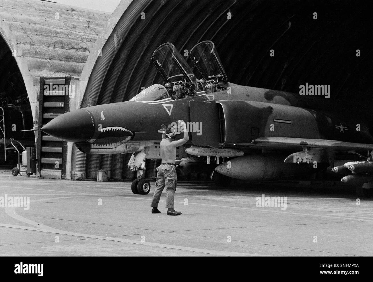 A U.S. Air Force F-4 Phantom jet is guided out of its revetment, April ...