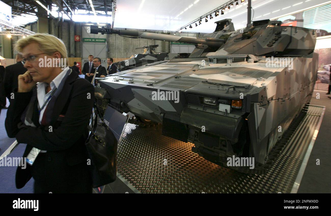 Bae Cv A journalist stands by a CV 9035 MkIII combat vehicle by BAE System U.K ...