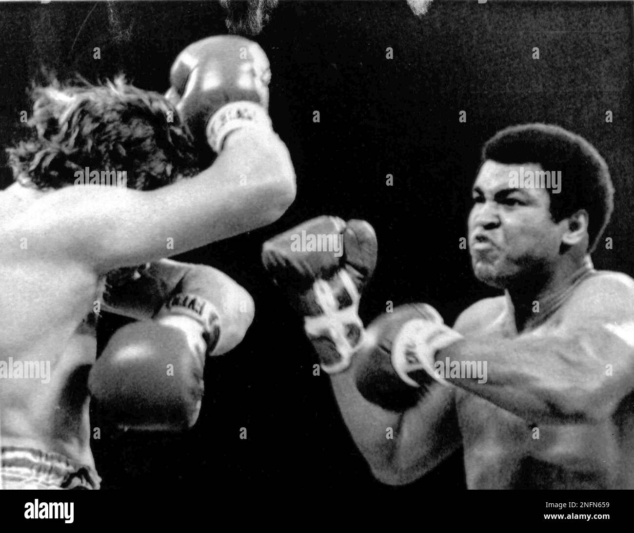 American heavyweight boxer Muhammad Ali, right, throws a flurry of