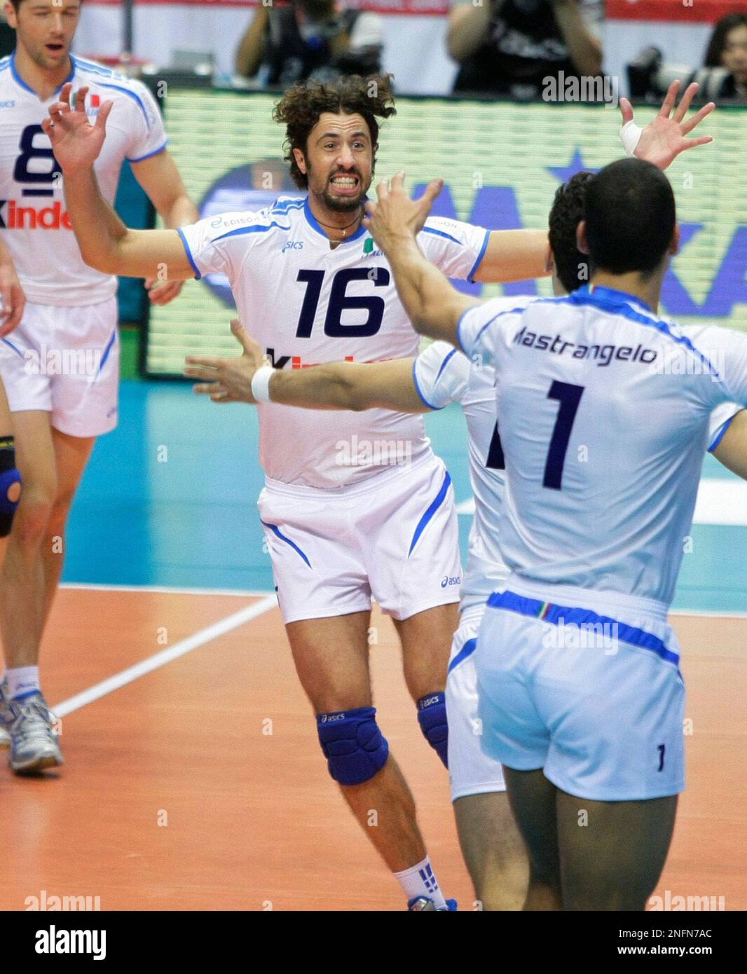 Italy s volleyball players Vigor Bovolenta 16 and Luigi Mastrangelo 1 celebrate after winning the match against argentina in the FIVB men s volleyball world final qualification tournament for the Beij...