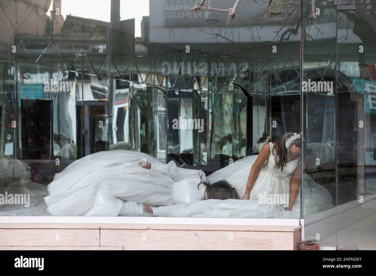 A view shows fallen mannequins in a damaged wedding dress shop, in the