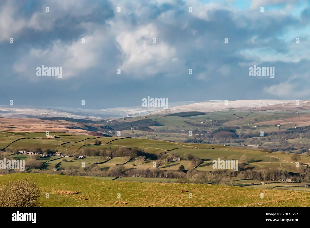 The view from Bail Hill above Mickleton looking up the dale towards  Harwood in the far distance (where the snow line starts) and Ettersgill. Stock Photo