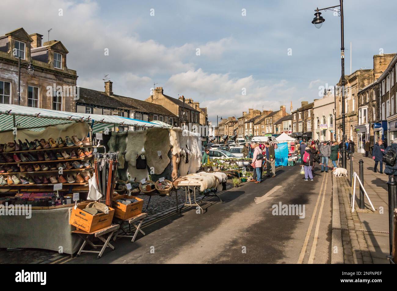 Shoppers and visitors exploring Barnard Castle market stalls on a bright February morning Stock Photo