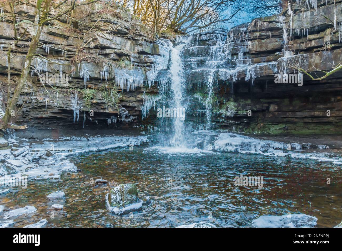 A 3-shot HDR image of a very cold and icy Summerhill Force Waterfall and Gibson's Cave. Stock Photo
