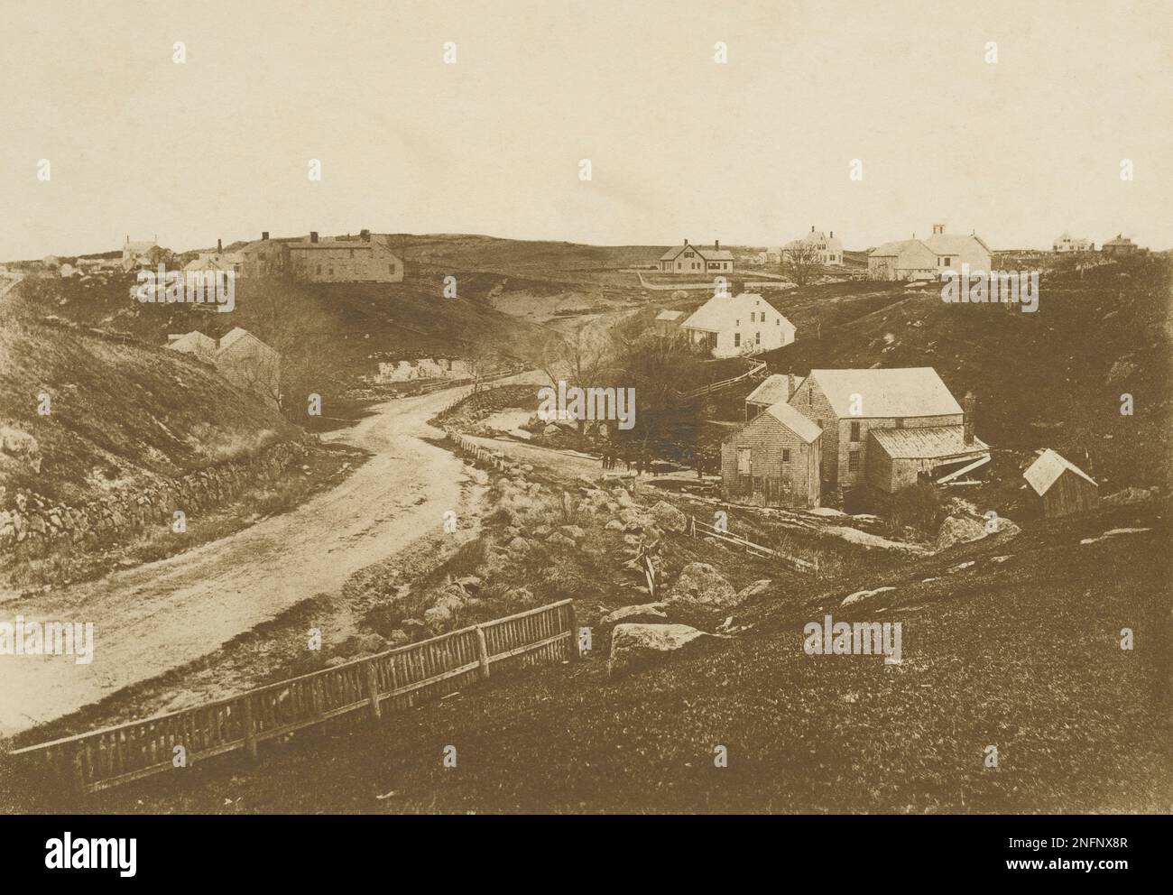 Antique c1880 photograph, showing the Stony Brook Mill site. To the right of the road are the woolen mill and tannery. To the center left of the road, peaking above the low hill, is the Perry home, destroyed by fire in 1898. Location: Brewster, Cape Cod, Massachusetts. SOURCE: ORIGINAL PHOTOGRAPH Stock Photo