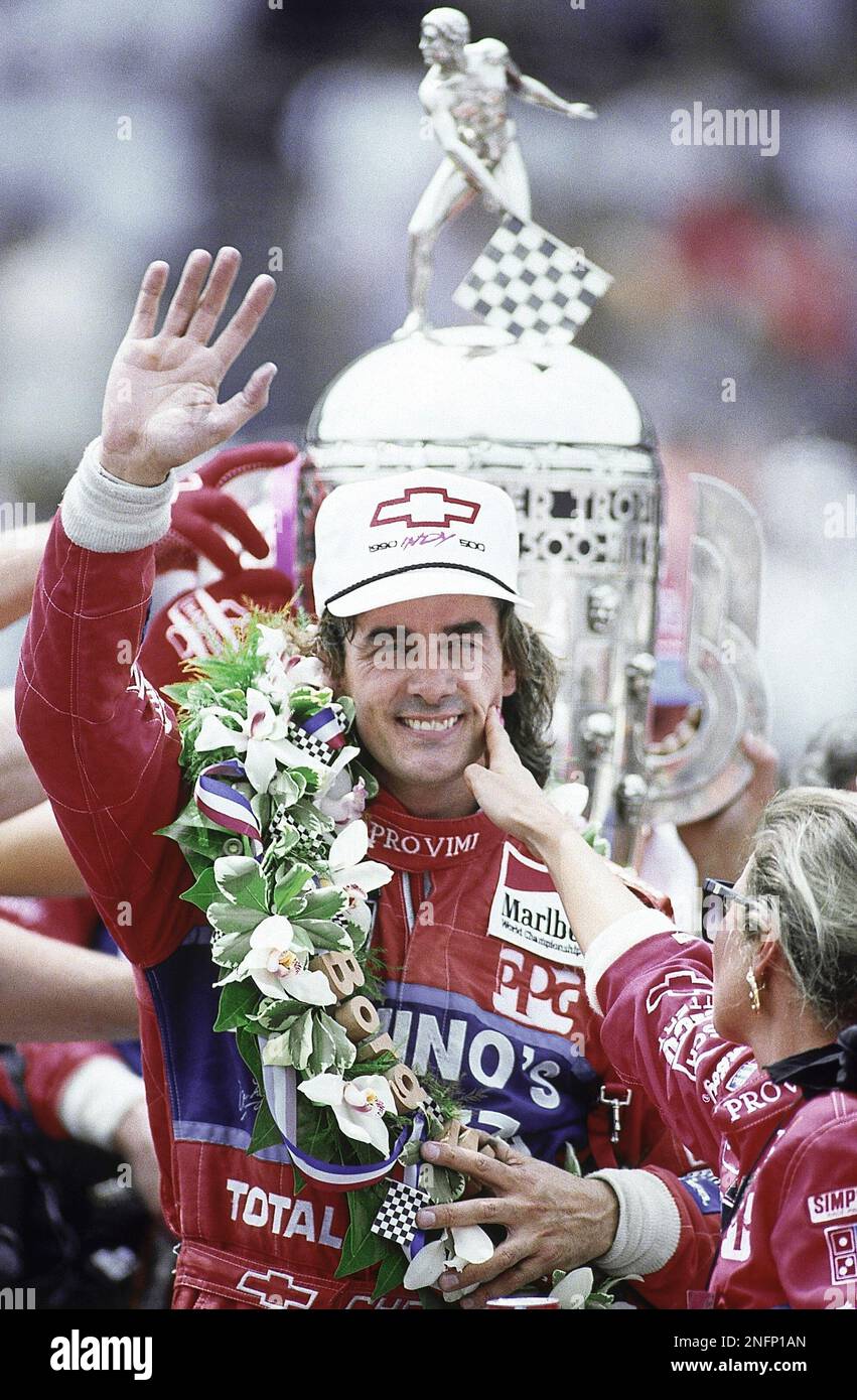 Race driver Arie Luyendyk waves to the crowd as his wife Mieke, right ...