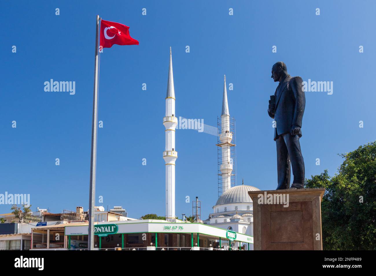 Turgutreis central mosque with statue and flag Stock Photo