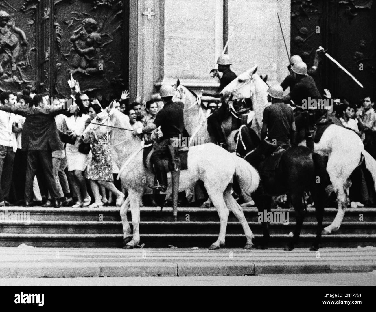 State Police cavalrymen swing Sabers as they charge students on steps