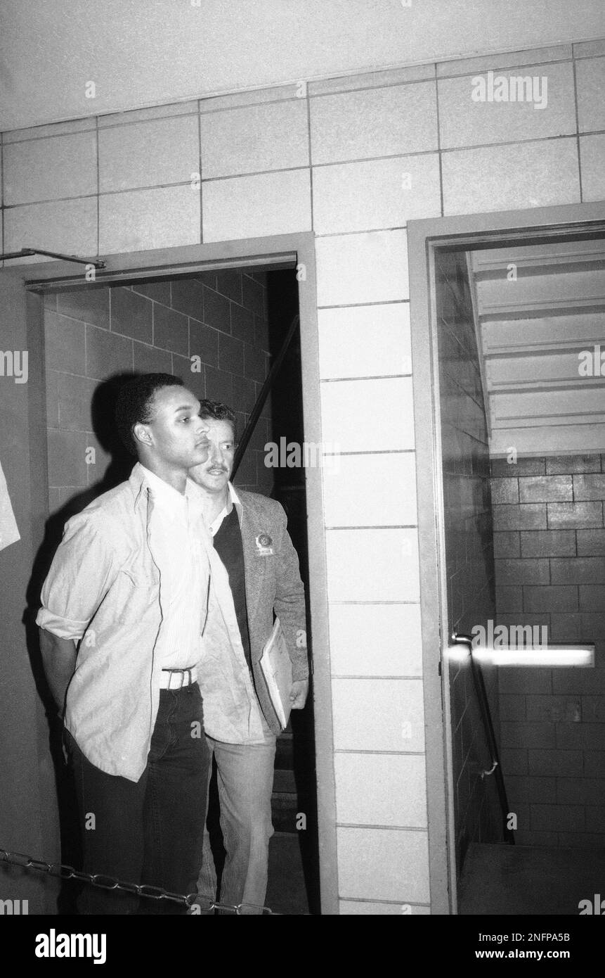 David Hampton, left, of Buffalo, N.Y., is escorted by an unidentified