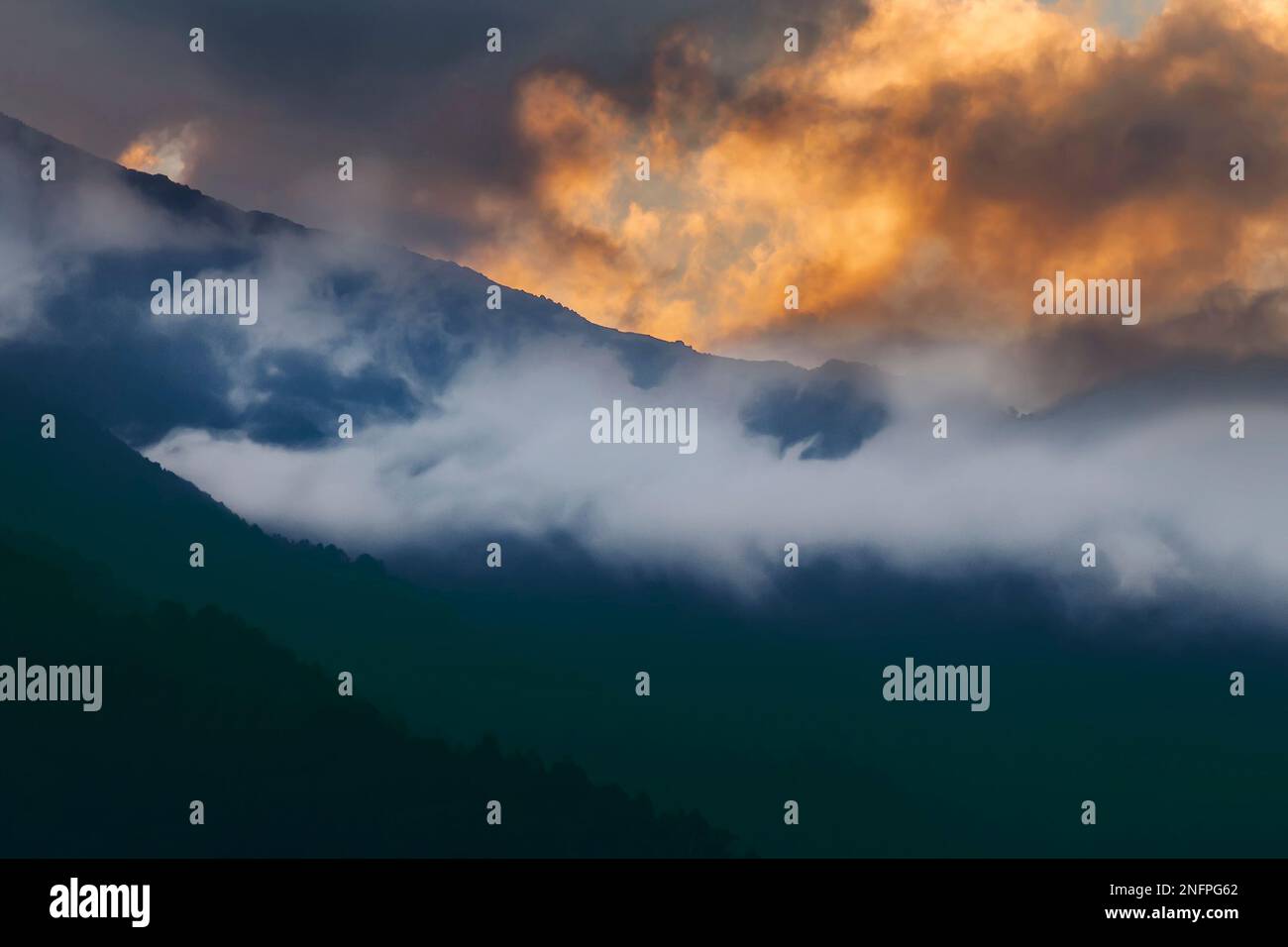 White cloud of the Himalayan mountain range, sun set sky in the background. Shot at Okhrey, Sikkim, India. Stock Photo