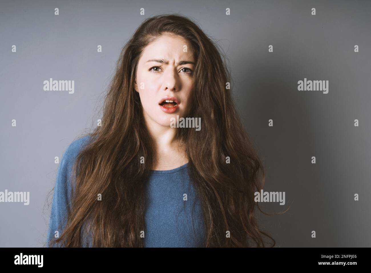 stunned shocked young woman is taken aback and left speechless with open mouth Stock Photo