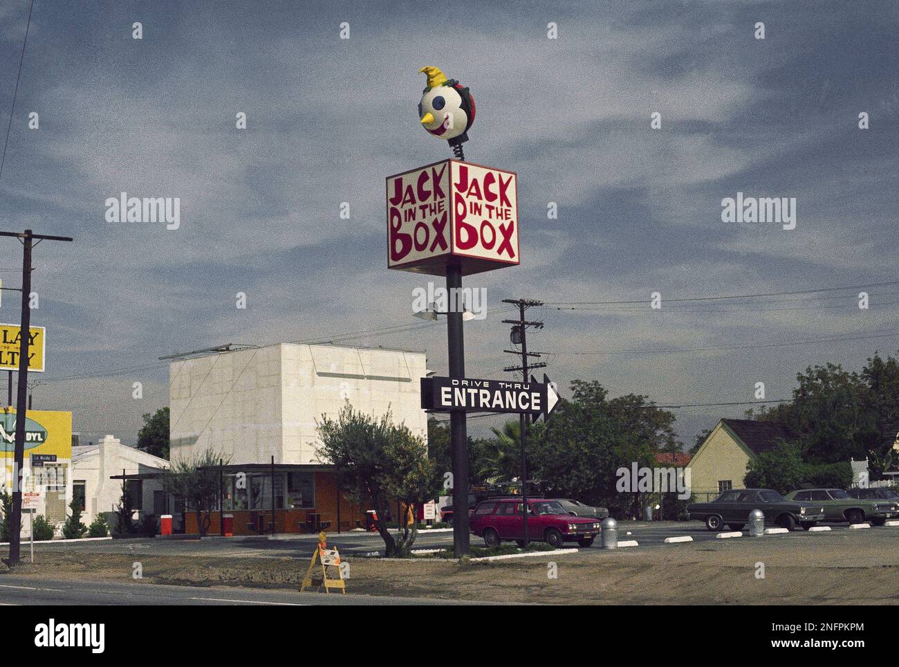 A restaurant with an eye-catching sign, Jack in the Box, is shown