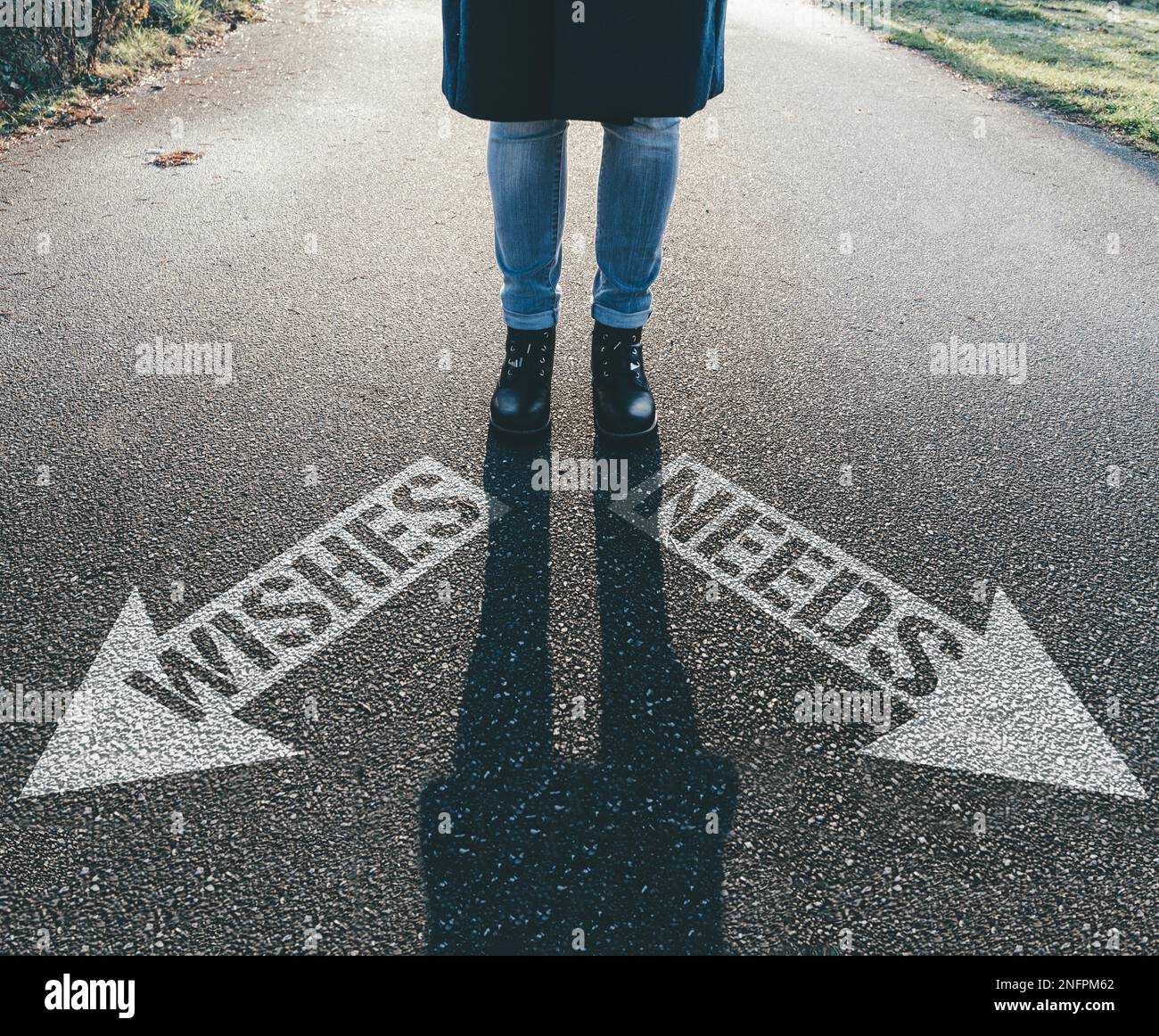 person standing behind arrows on asphalt pointing in different