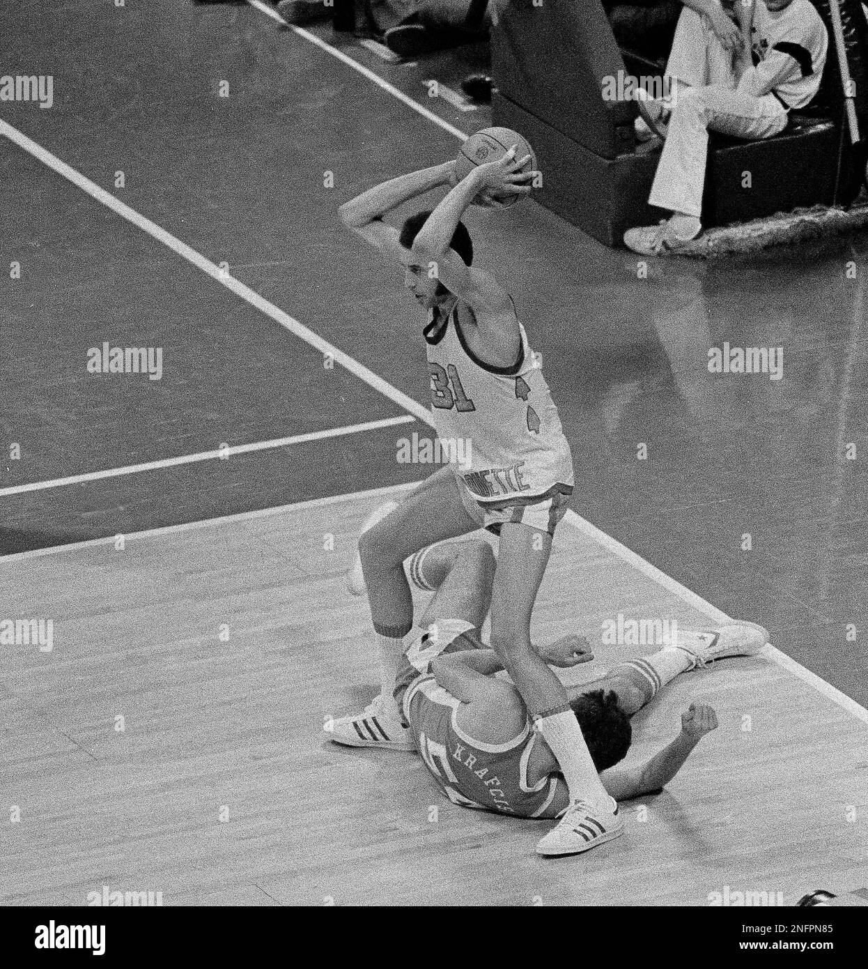 Marquette's Bo Ellis (31) towers over North Carolina's Steve Krafcisin (54)  on the floor during NCAA basketball championship game March 28, 1977 in  Atlanta, GA. (AP Photo Stock Photo - Alamy