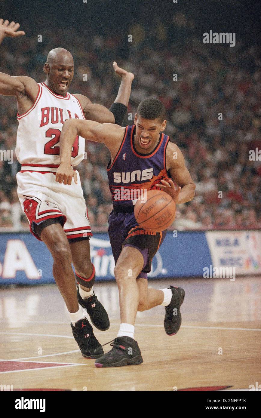 Phoenix Suns' Kevin Johnson, right, drives pats Chicago Bulls