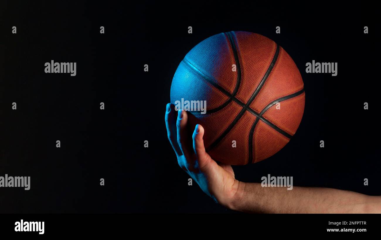 front view basketball held by male hand Stock Photo
