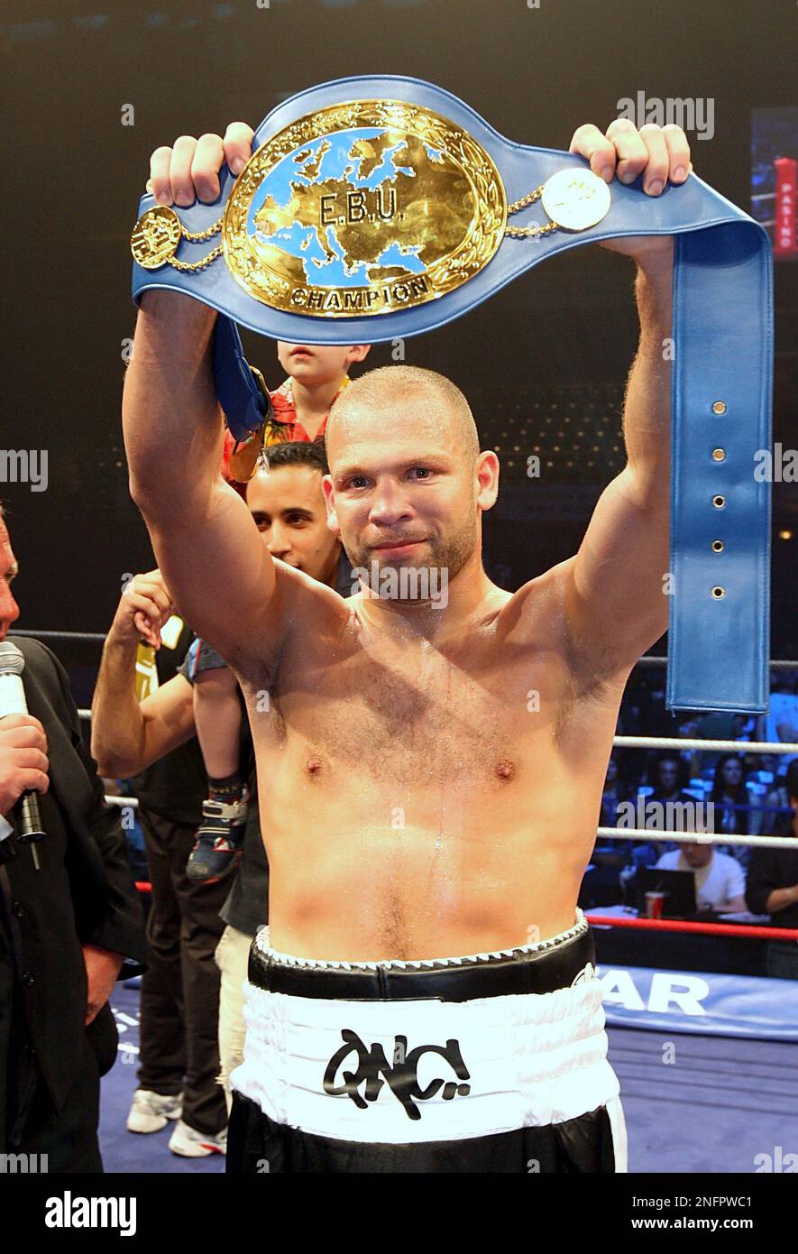 French challenger Jean-Marc Monrose holds up his title belt