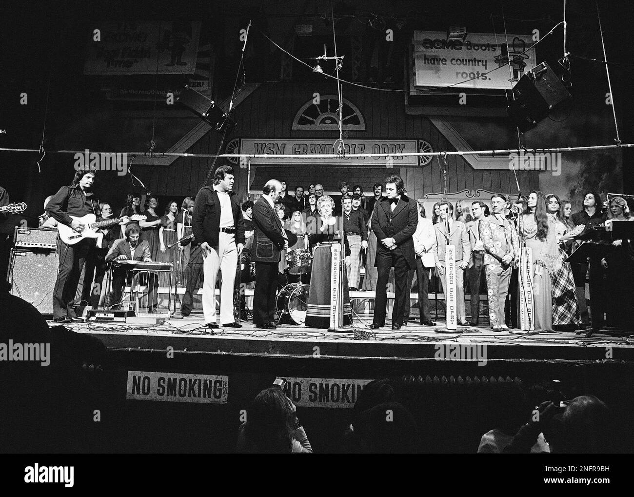 Country singer Maybelle Carter, center, is flanked by Johnny Cash