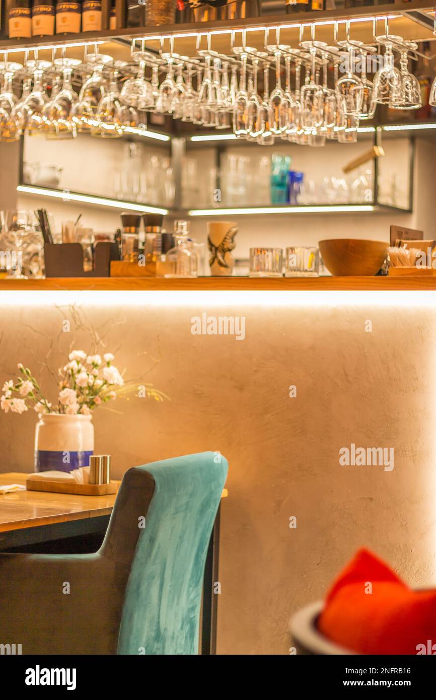Restaurant interior, blurred. Empty bar counter with hanging glasses