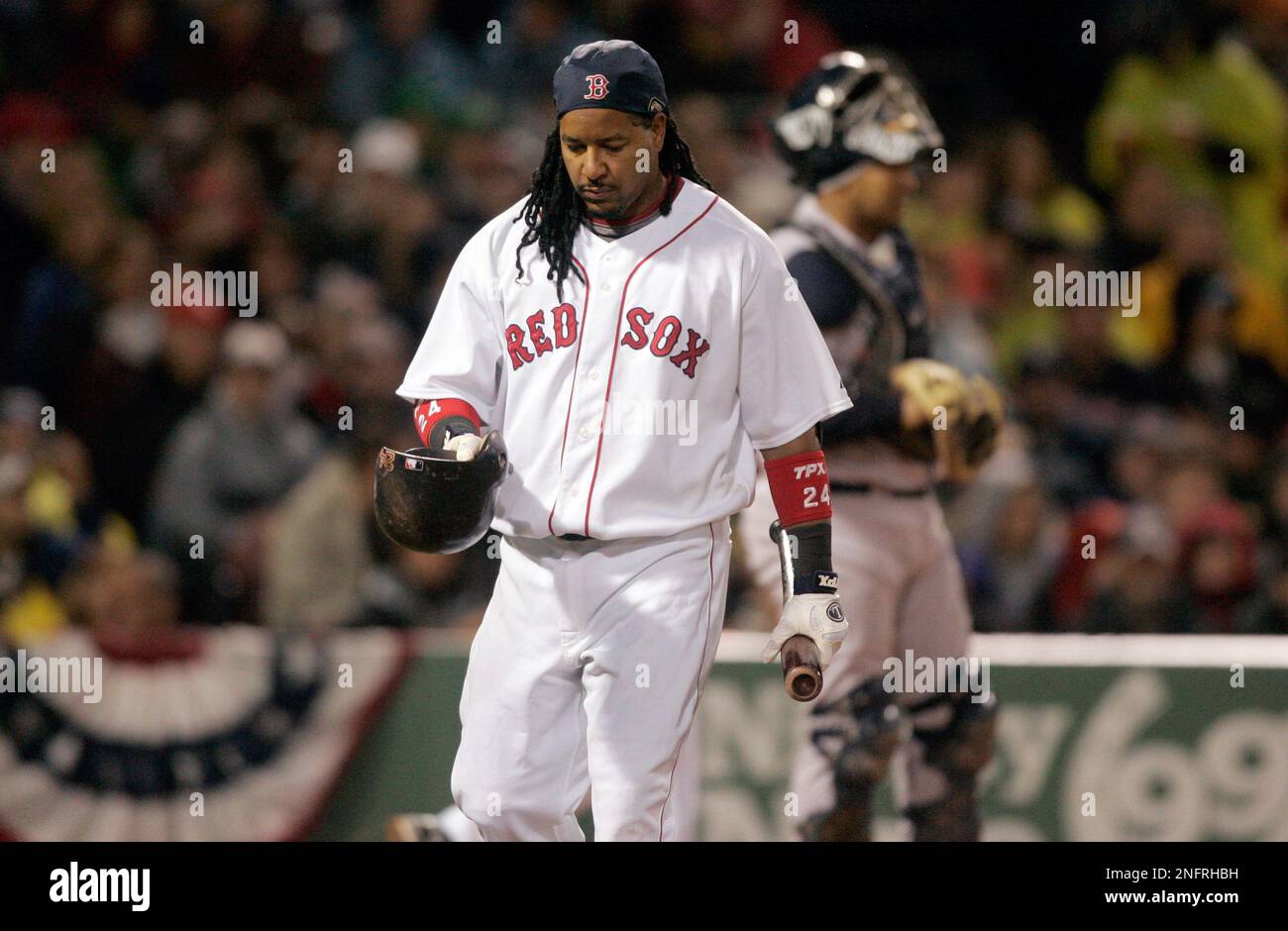 Boston Red Sox's Manny Ramirez kisses a bat as he returns to the plate from  the dug out after breaking a bat in the first inning of a baseball game  against the