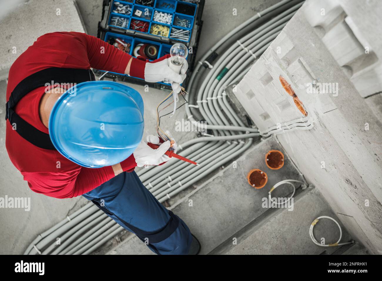 Top View of Professional Electrician Checking Wires While Performing