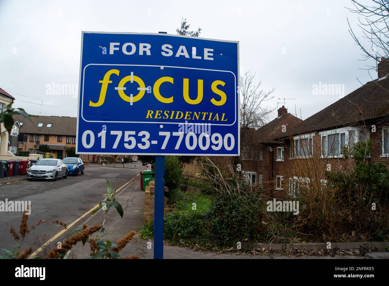 Slough, Berkshire, UK. 17th February, 2023. A For Sale Sign outside a block of maisonettes in Slough Town Centre, Berkshire. It has been reported in the press today that UK house prices could fall by as much as 40%. The number of buyers is begining to dry up as people are concerned about buying homes if the prices are to fall, whereas meanwhile, those selling properties don't want to reduce the price. Experts are predicting house prices could take a massive fall as they did in the 1990s when many people found themselves in a negative equity situation. Credit: Maureen McLean/Alamy Live News Stock Photo