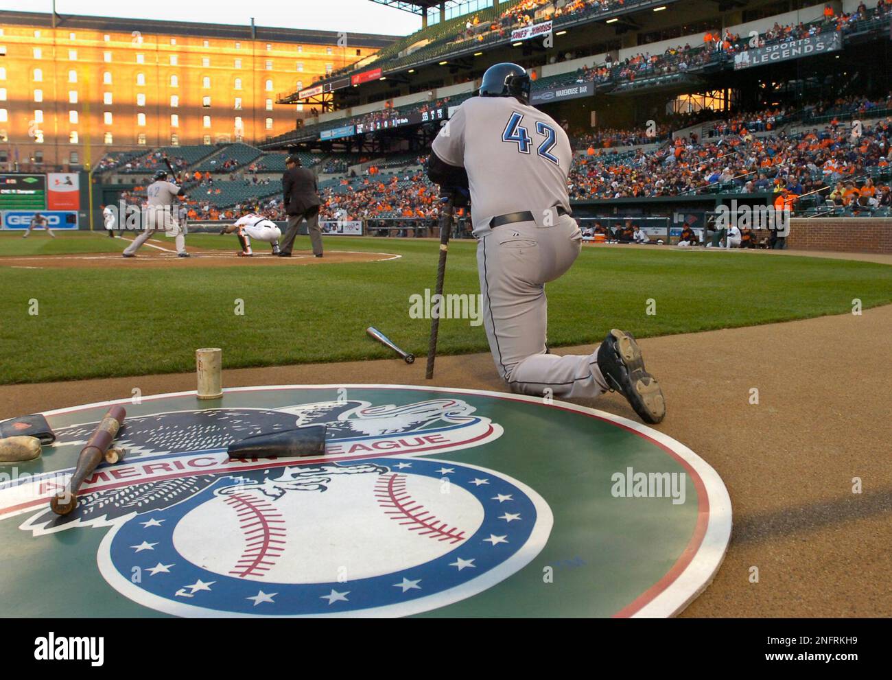 Toronto Blue Jays Frank Thomas kneels in the on deck circle and Vernon  Wells at bat both wear jersey number 42 in honor of Jackie Robinson in the  first inning of a