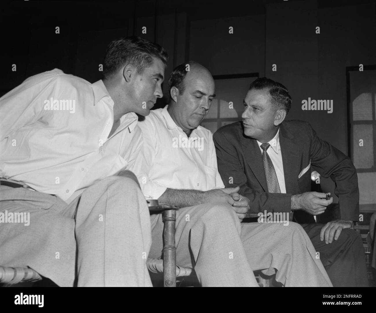 Halfbrothers Roy Bryant, left, and J.W. Milam, center, listen to their