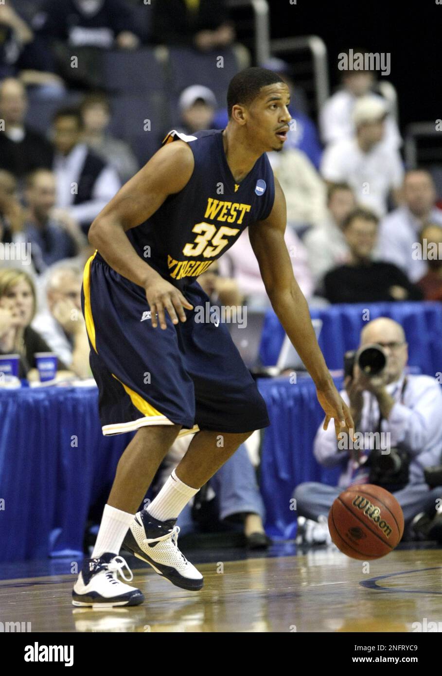 West Virginia's Wellington Smith 35, handles the ball during first